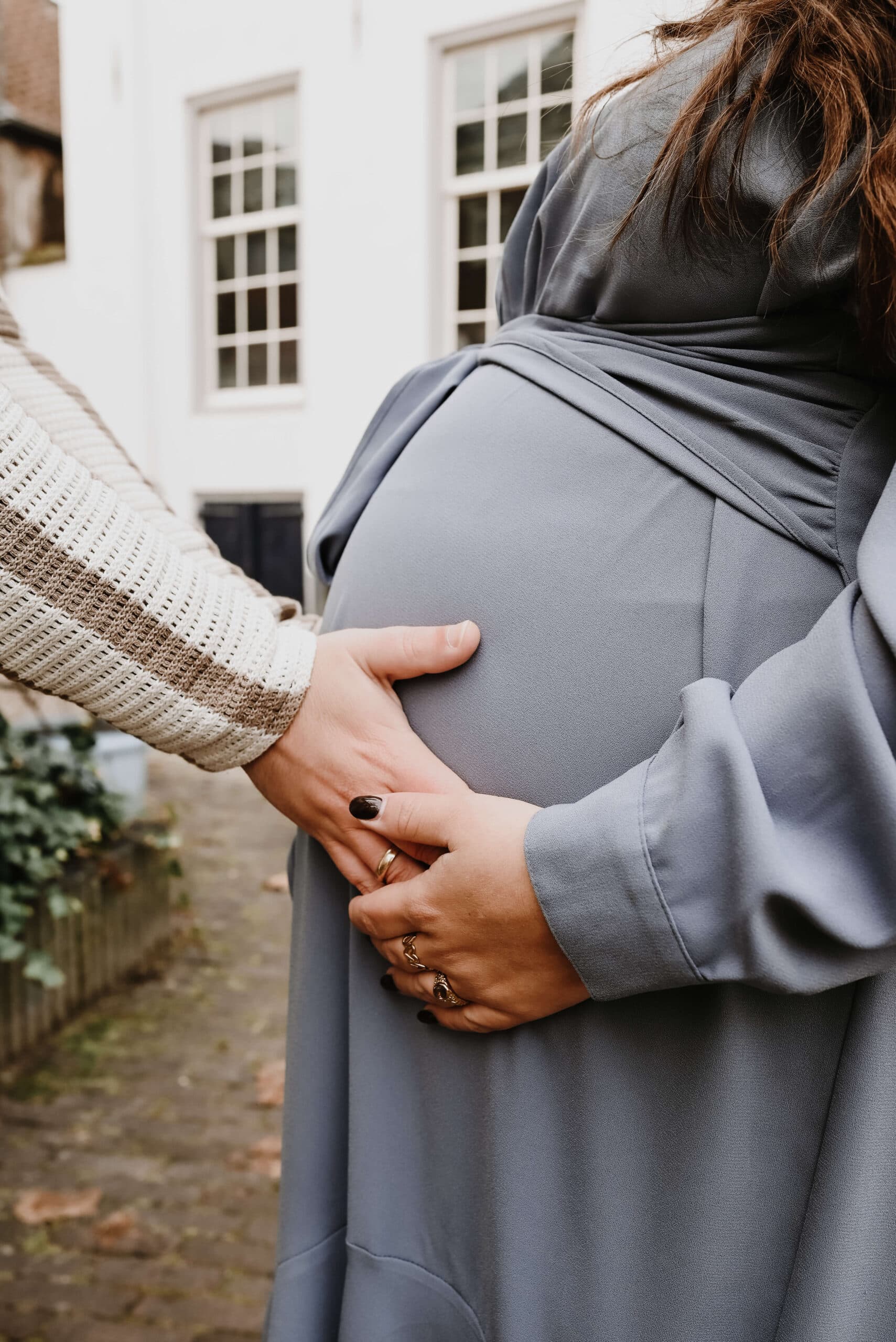Handen van aanstaande ouders op de babybuik – Studio Roos Fotografie